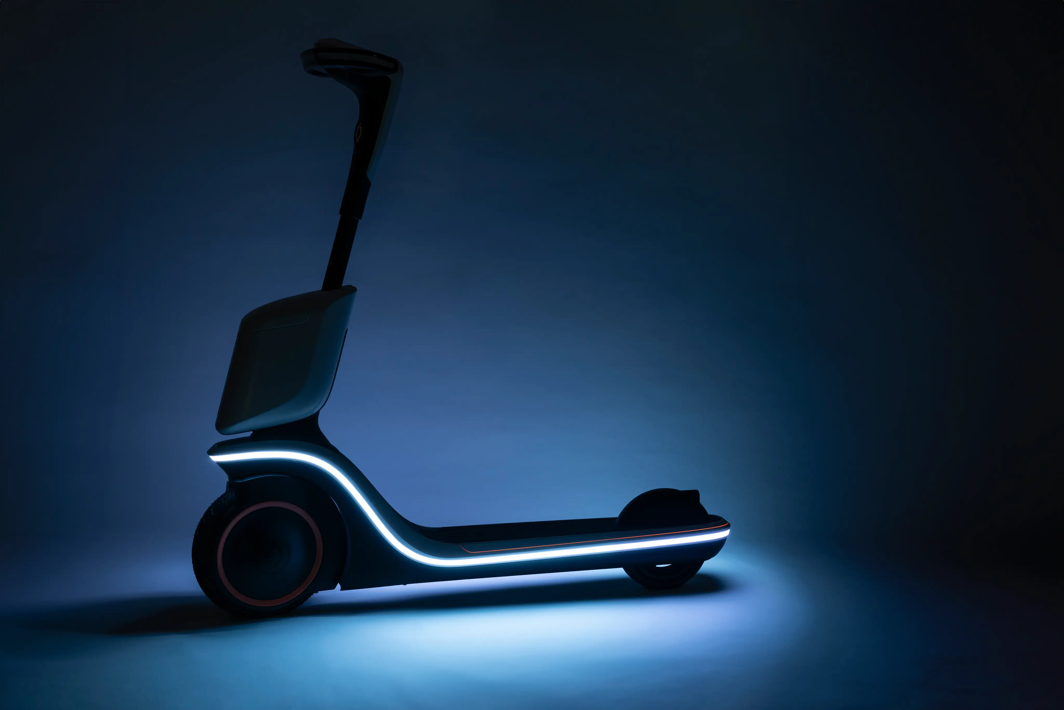 Modern electric scooter illuminated with blue LED lights in a dark setting.