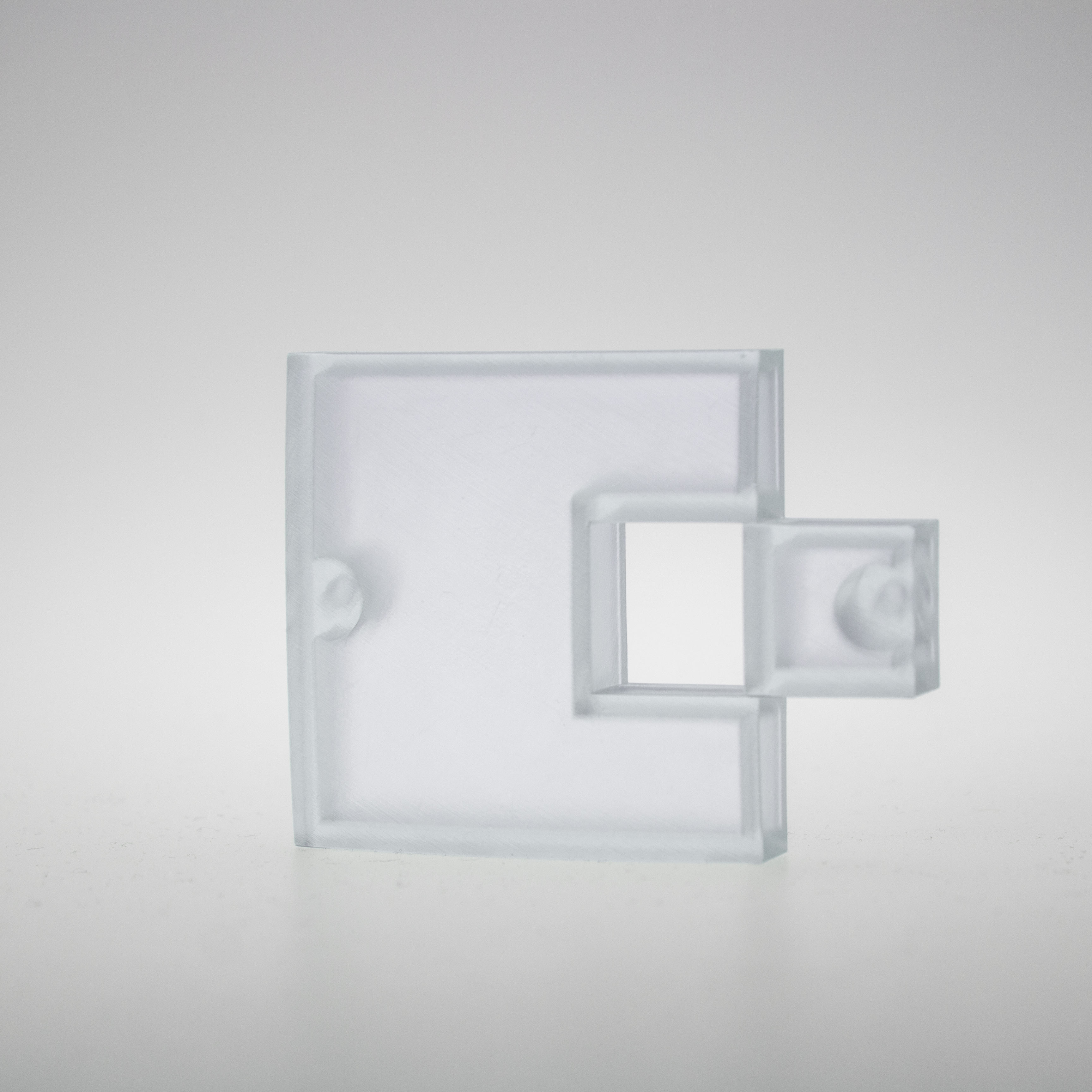 Hands wearing blue gloves handling a small transparent container with a clear liquid and a pipette over a water surface.