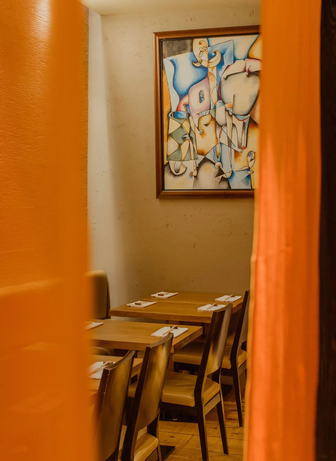 A shot of the dining space at Bar Masa, with the orange curtains slightly out of focus