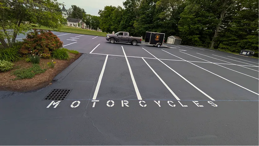 Commercial driveway freshly seal coated and line striped