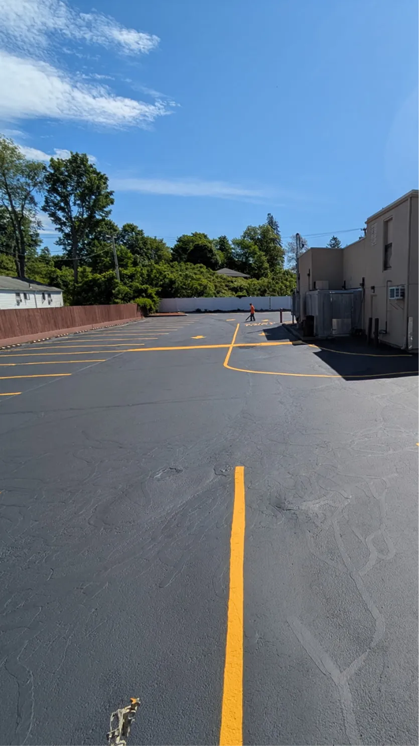 Commercial driveway freshly seal coated and line striped