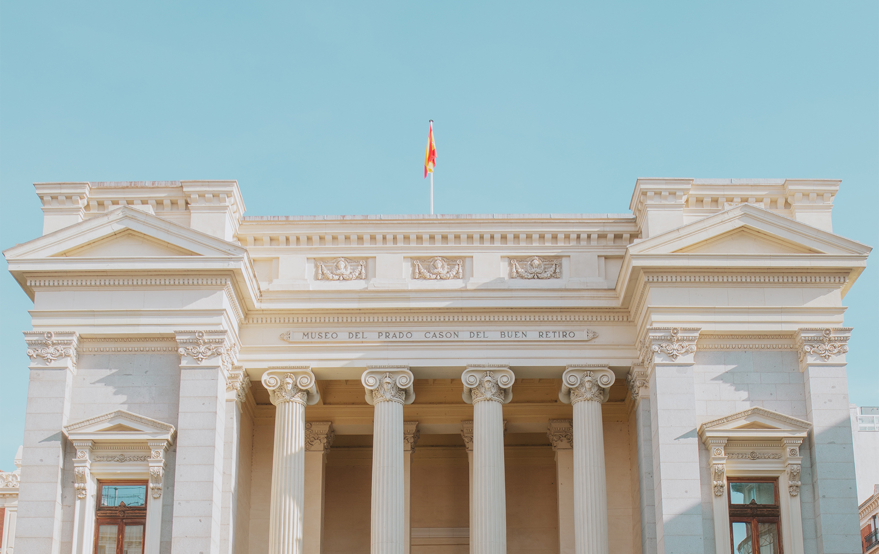 Orange flower on clear blue sky background.