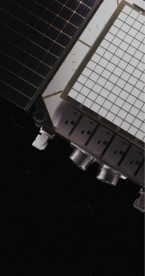 Engineers working inside the K2 Space manufacturing facility, assembling satellite components behind large glass panels