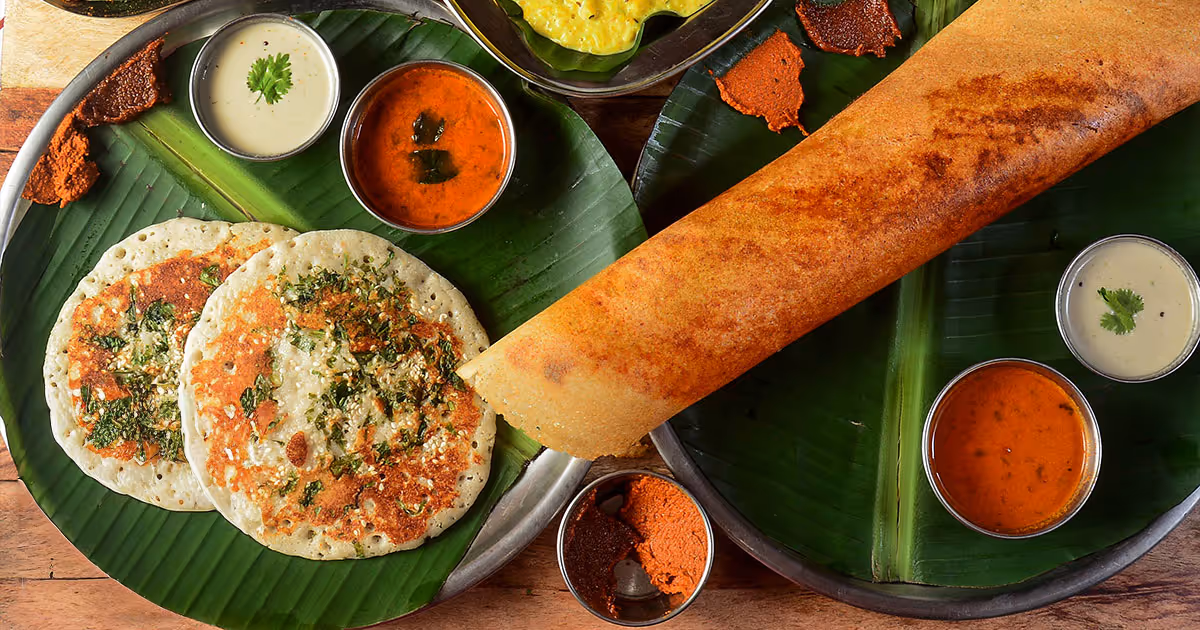 A plate of food with a large piece of bread and a bowl of sauce.