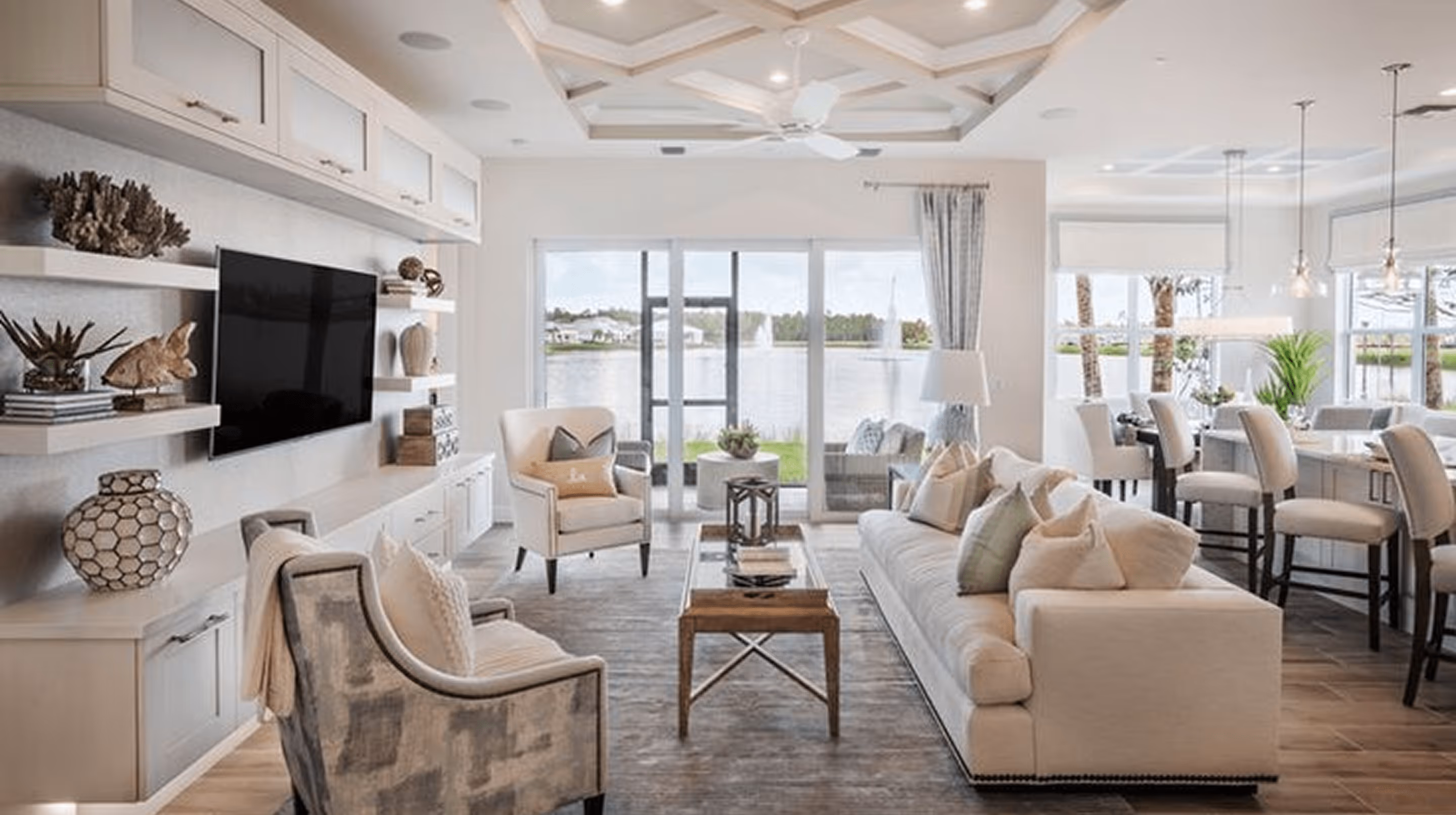 Modern living room with sofa, armchairs, and lake view - trusted home cleaning professionals in Nocatee and St. Johns