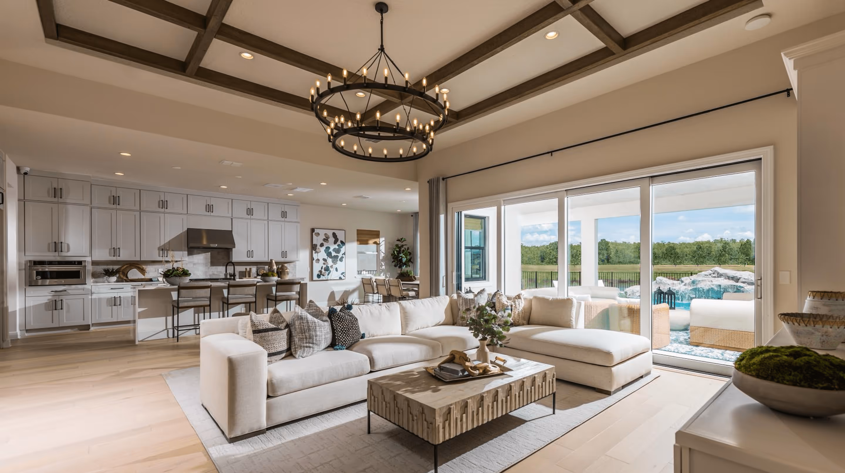 Open-concept living room with sectional sofa and pool view - luxury home cleaning services for St. Johns and Ponte Vedra families