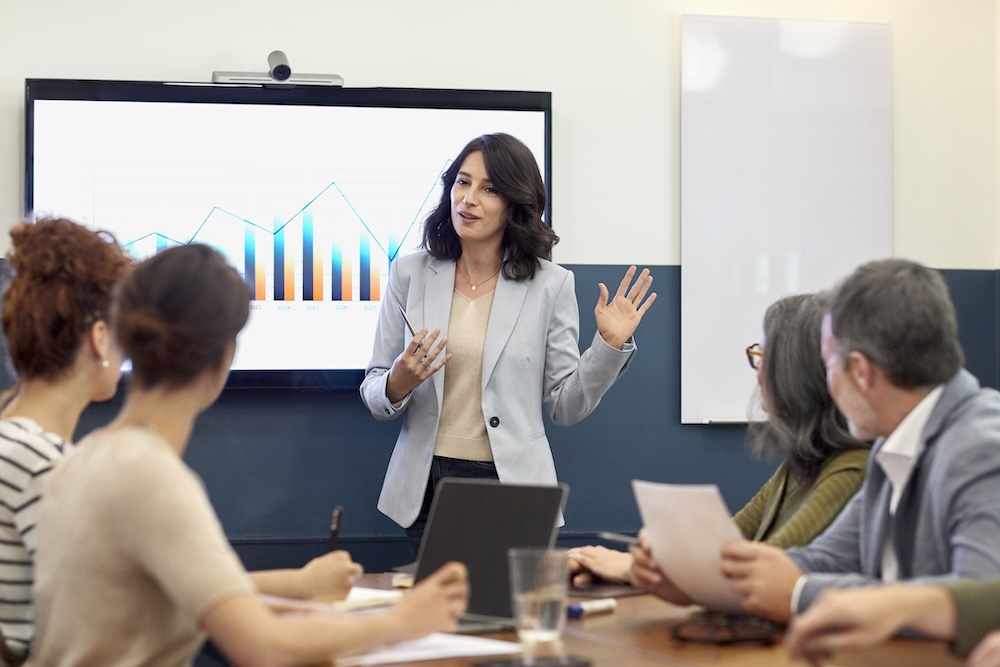 Woman presenting to a room of people