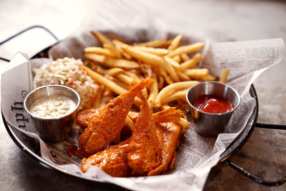 Plate of fried blowfish tails, sauce and french fries