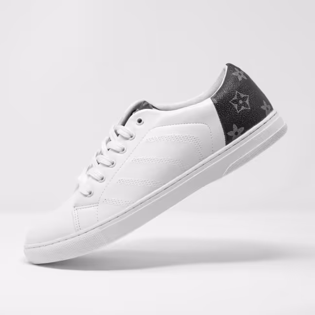 White sneaker with black heel featuring star and flower patterns on a light background.