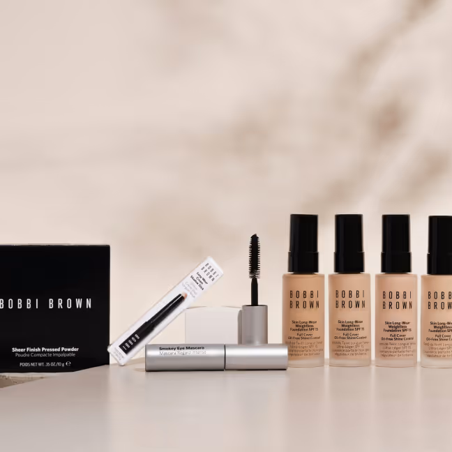 Bobbi Brown makeup products including Sheer Finish Pressed Powder, Smokey Eye Mascara, and four bottles of Skin Long-Wear Weightless Foundation SPF 15 in various shades.