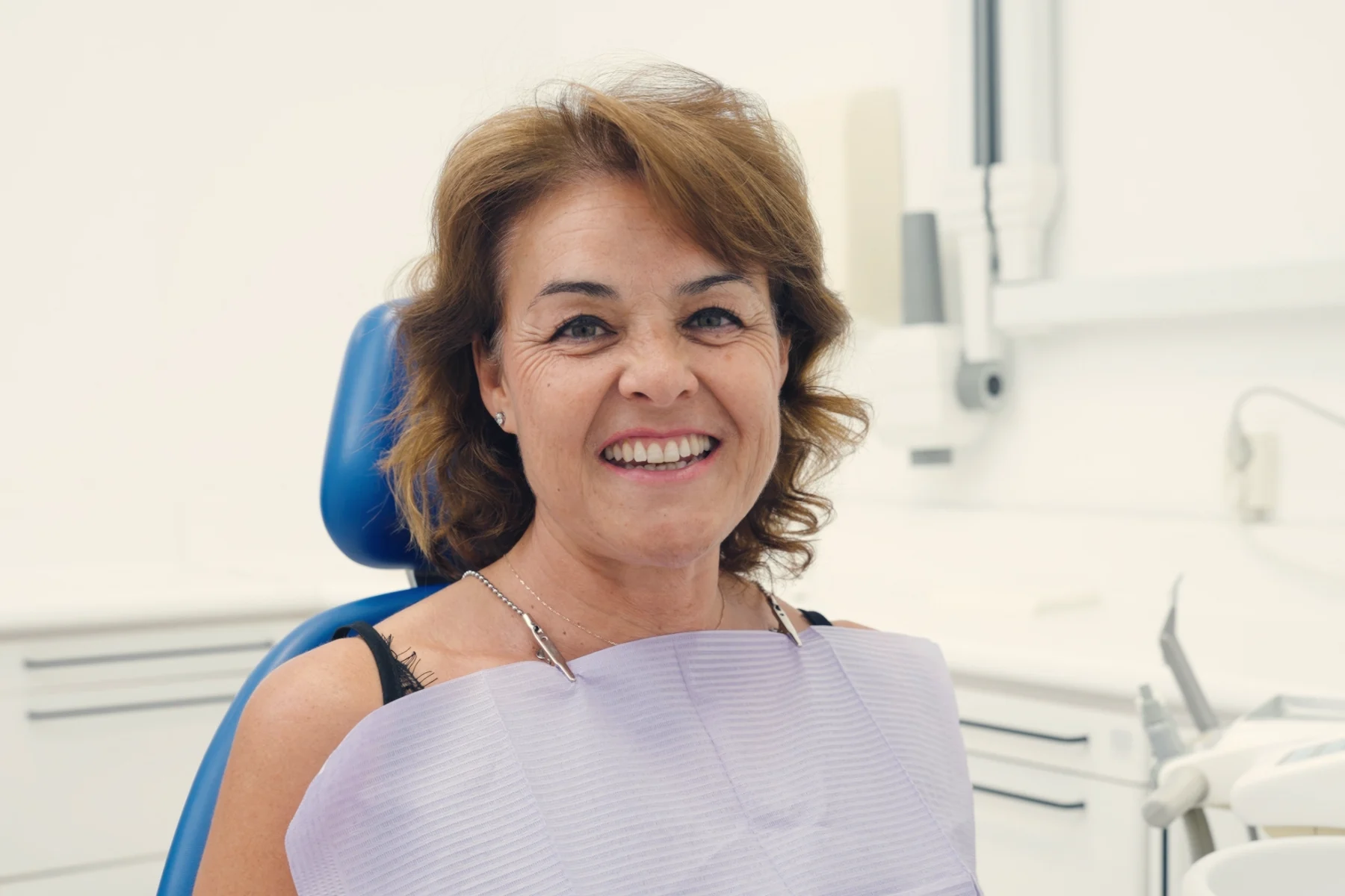 Smiling Latina patient in the dental chair after choosing a dentist in Kendall