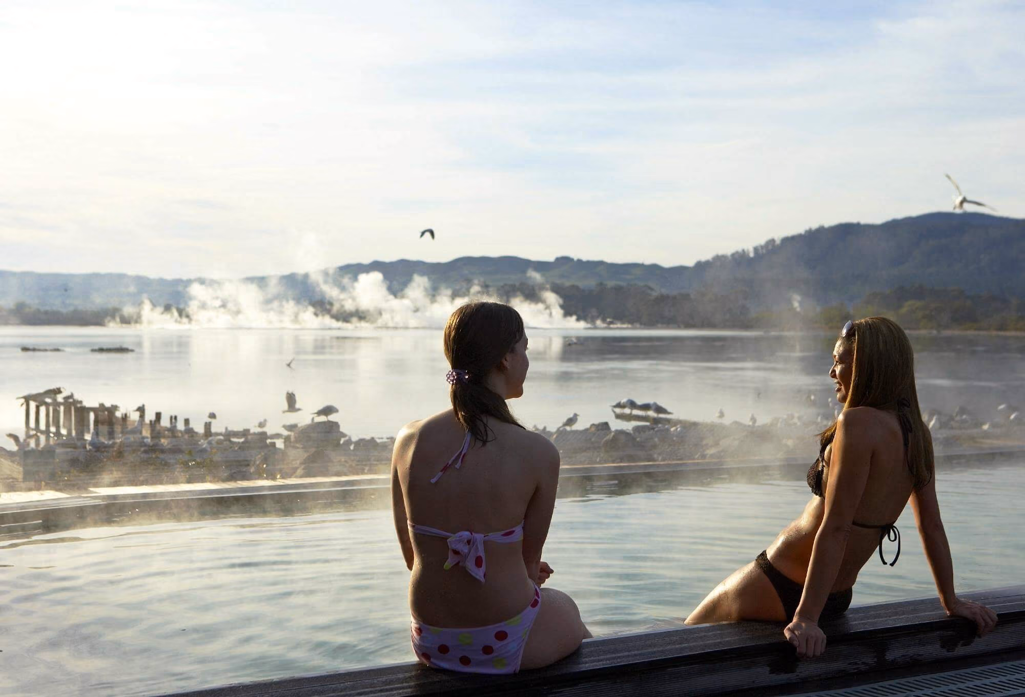 Geothermal hot spring pool in Rotorua New Zealand with rising steam, ranked fifth among the best places for hot springs