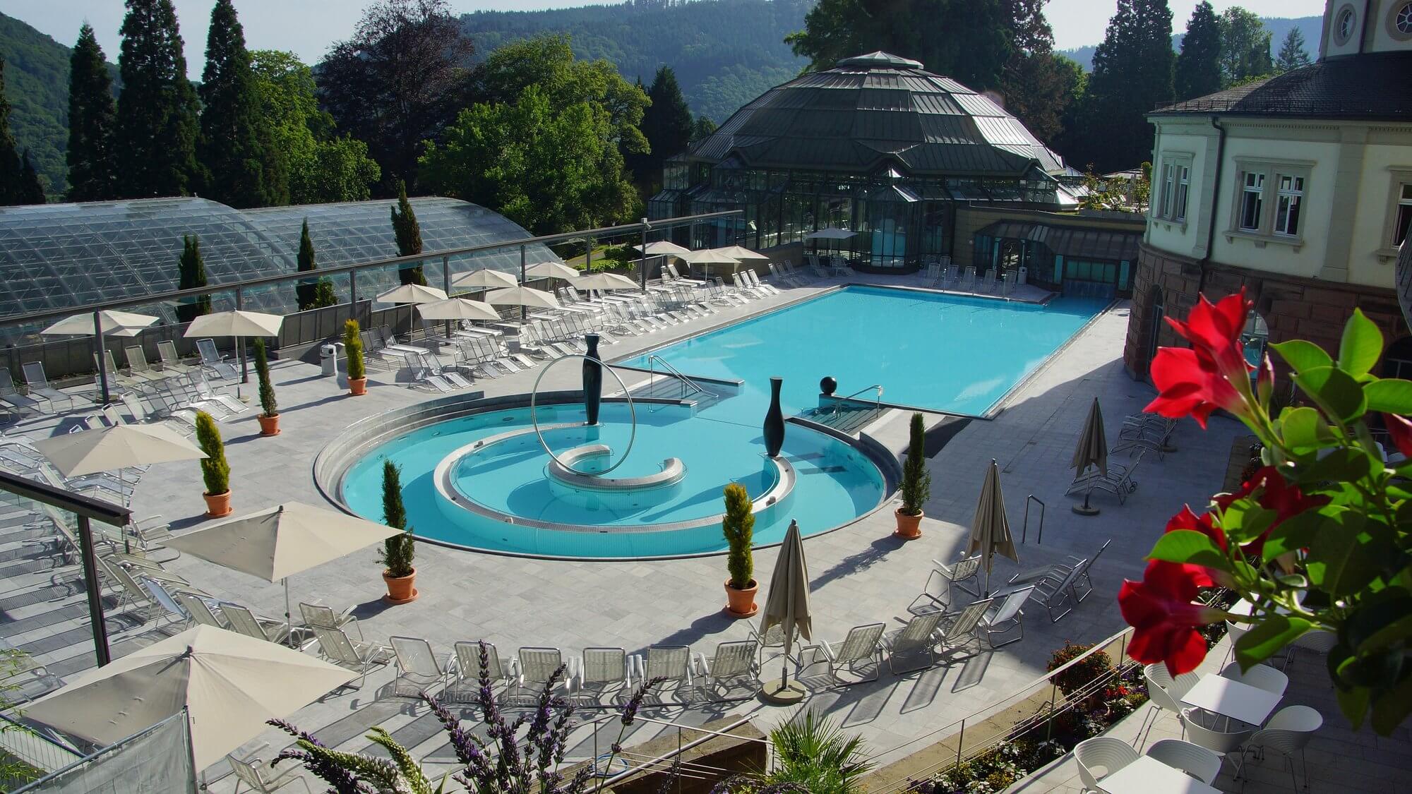 Outdoor thermal bath with valley view backdrop in Germany, illustrating German spa town heritage