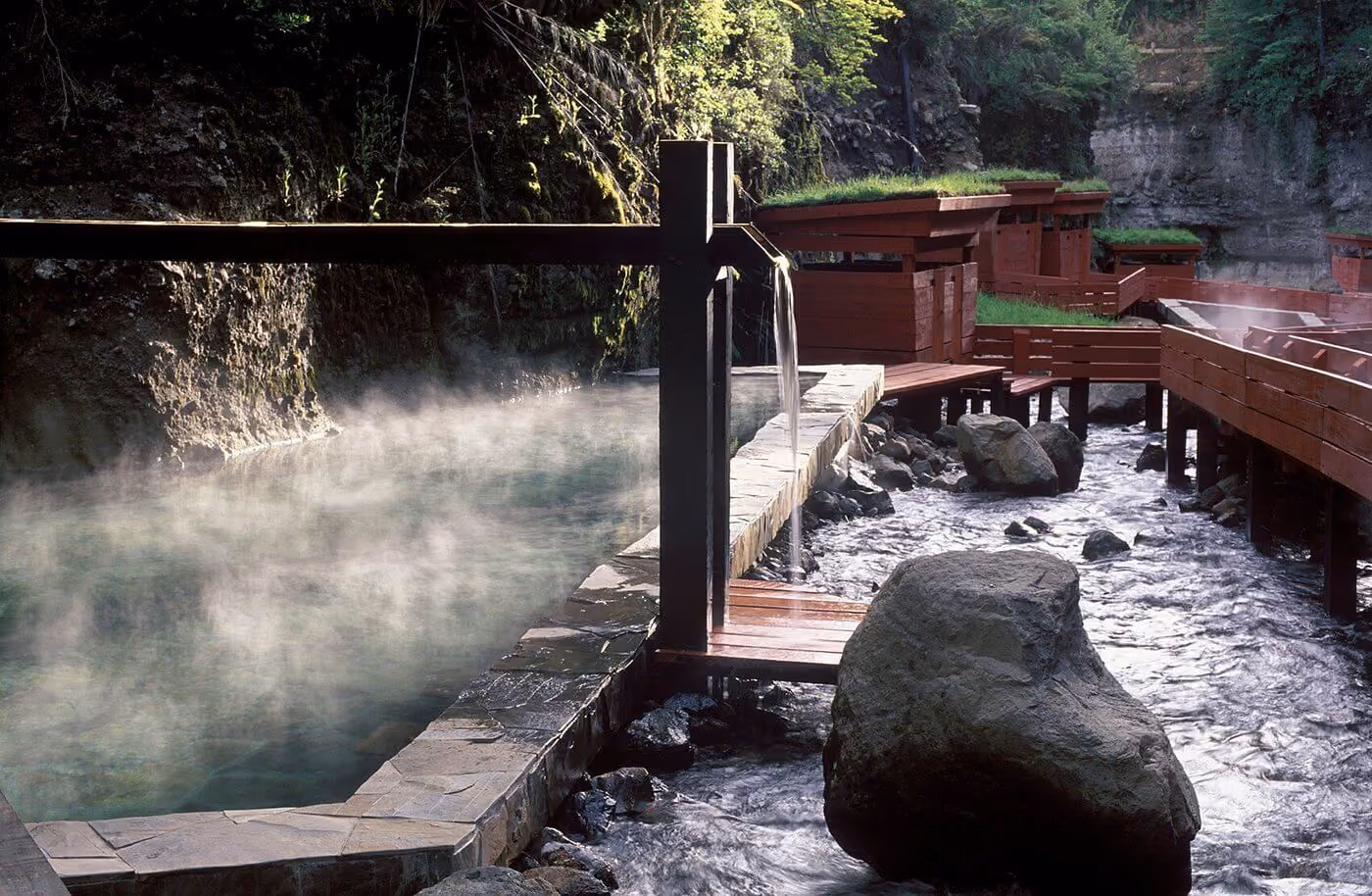 Termas Geometricas thermal pools connected by red wooden walkways in southern Chile, illustrating Chilean Andean hot springs