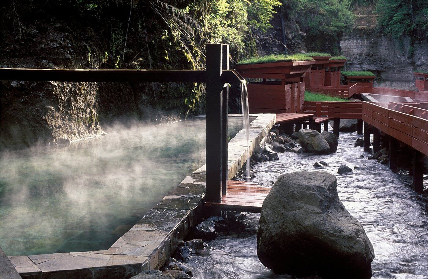  Termas Geometricas thermal pools connected by red wooden walkways in southern Chile, illustrating Chilean Andean hot springs
