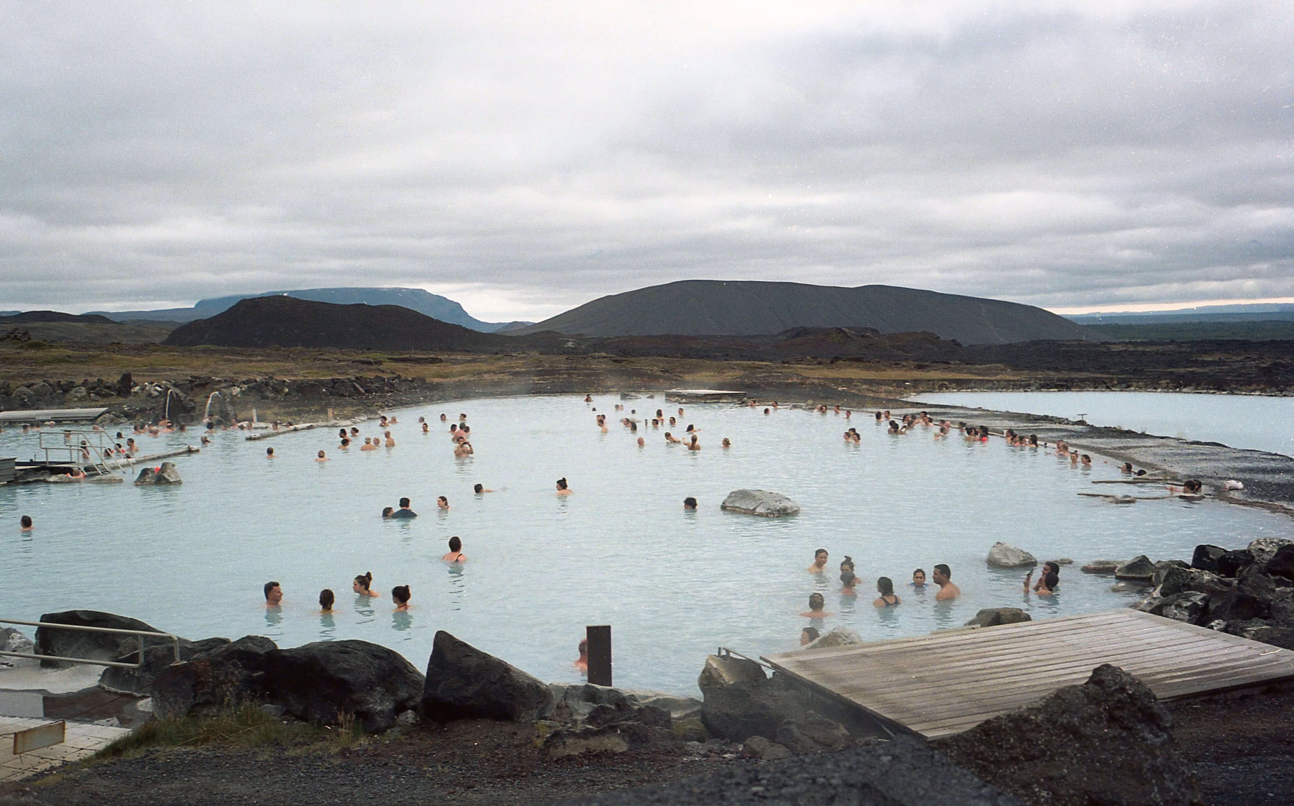 Natural geothermal pool in Iceland surrounded by black volcanic rock, ranked the best place for hot springs