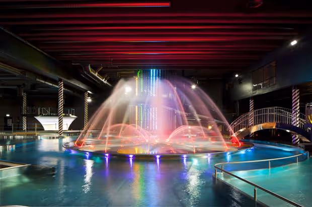 Indoor pool with neon lighted fountains at Holiday Club Saimaan Rauha Water Park & Day Spa, Finland