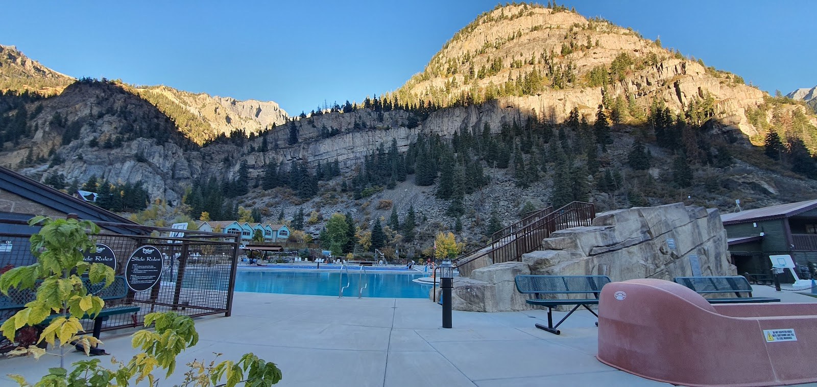 Ouray Hot Springs Pool in Colorado with a large clear outdoor pool and mountainous backdrop during late afternoon light.
