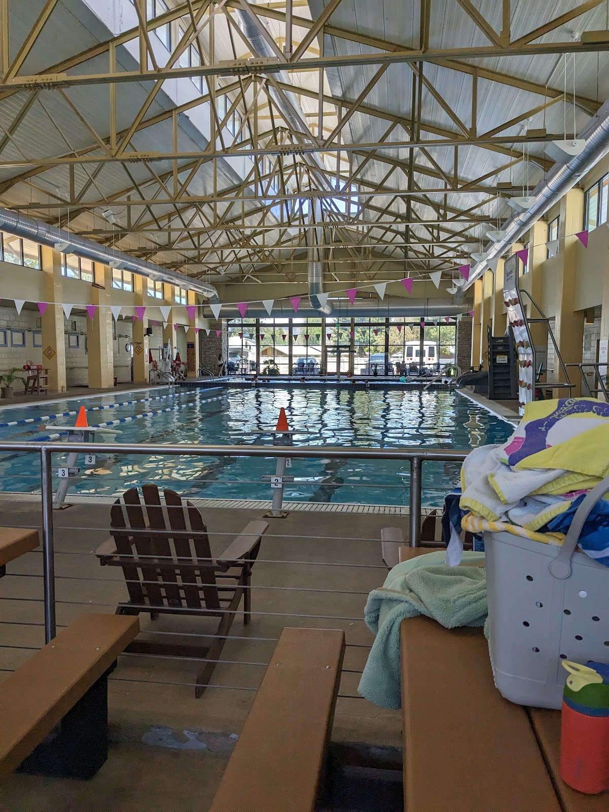 Indoor swimming pool at Salida Hot Springs Aquatic Center showing water, seating, and high ceiling with skylights in Salida, Colorado.