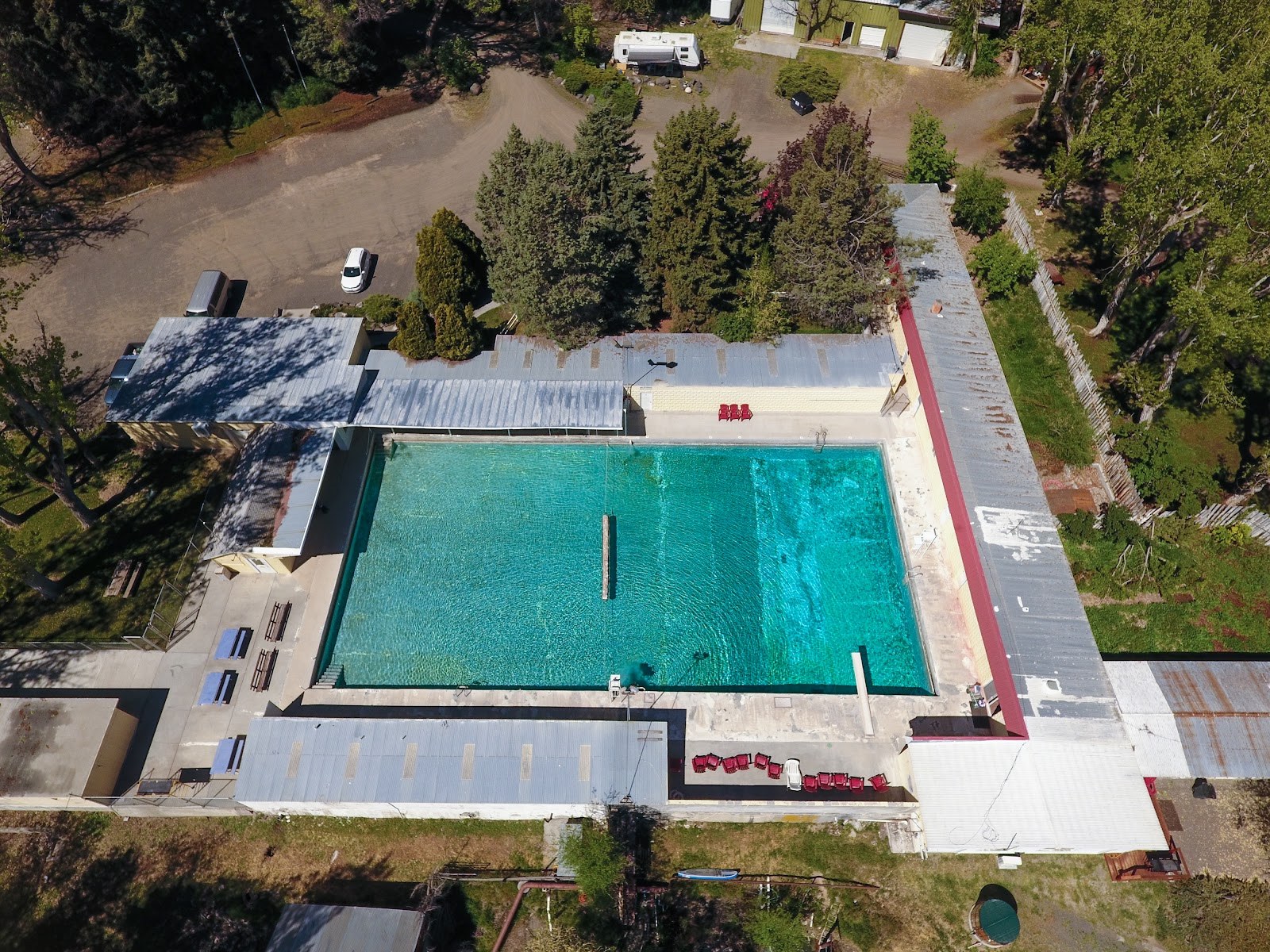 Aerial view of the rectangular outdoor pool at Banbury Hot Springs surrounded by trees and structures in Buhl, Idaho, United States