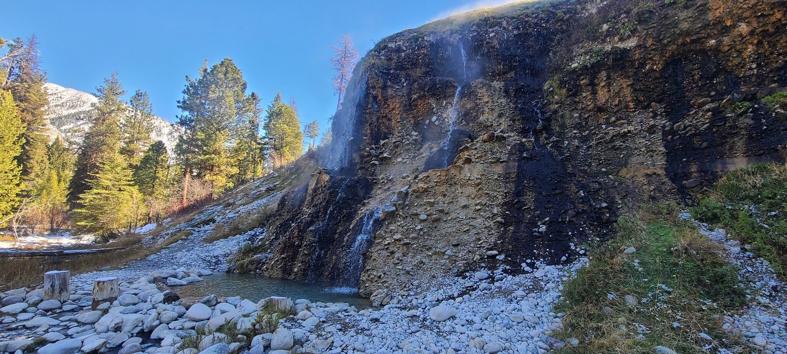 Steaming hot spring pool with cascading waterfall and rocky terrain at Chattanooga Hot Springs, located near Atlanta in Idaho, USA.