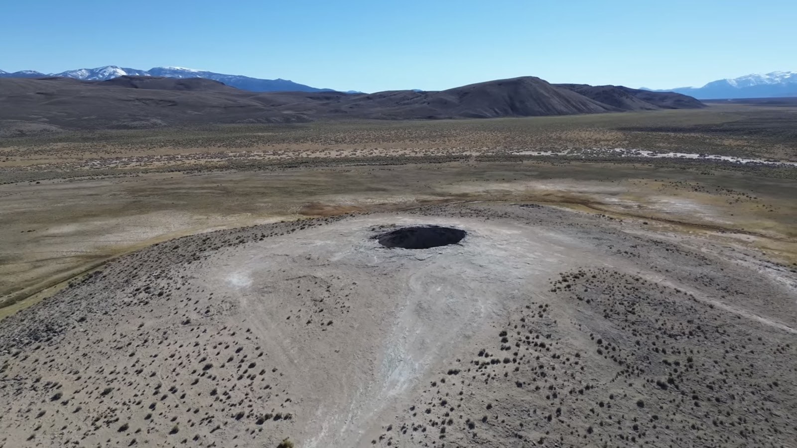 Aerial view of Diana’s Punch Bowl crater showing barren terrain and distant mountains near Round Mountain, Nevada, United States