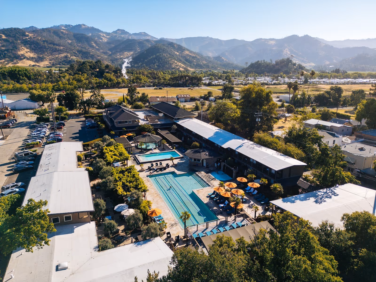 Aerial view of Calistoga Spa Hot Springs showing multiple pools and buildings with mountains in the background near Calistoga California.