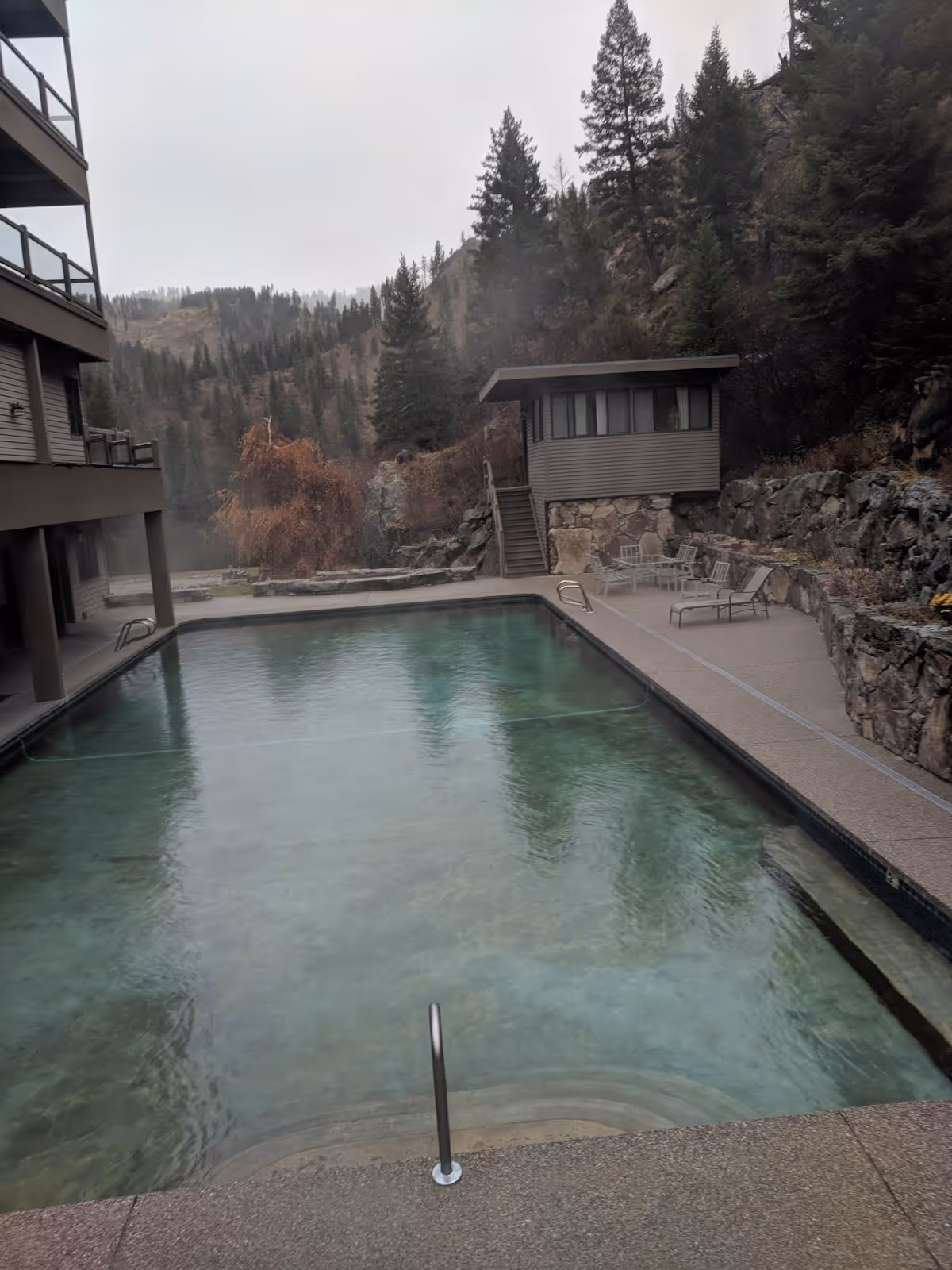 Outdoor rectangular hot spring pool with clear water and light steam at Sleeping Child Hot Springs near Hamilton montana.