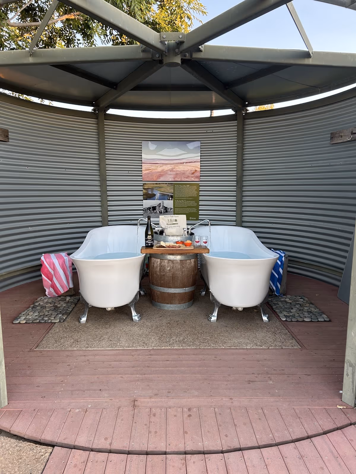 Twin white clawfoot bathtubs filled with water under a covered pavilion at Julia Creek Artesian Baths near Julia Creek Queensland.