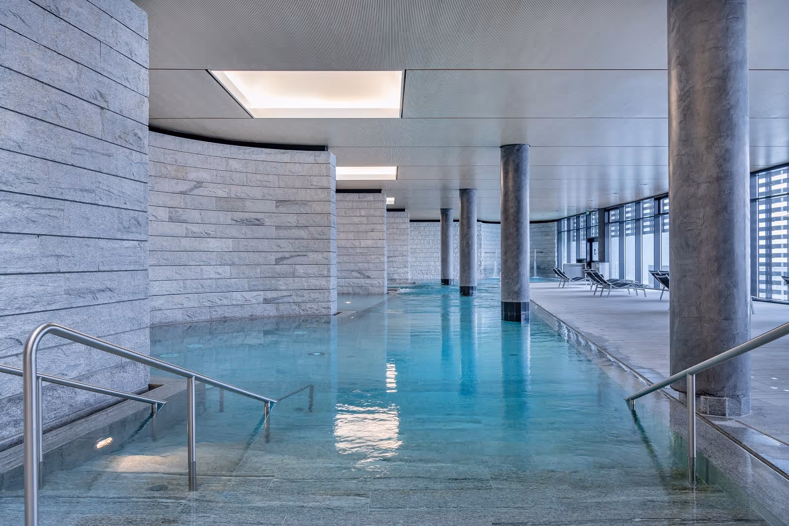 Indoor mineral pool at Mineralbad & Spa Rigi Kaltbad with clear blue water and stone walls in Rigi Kaltbad, Switzerland.