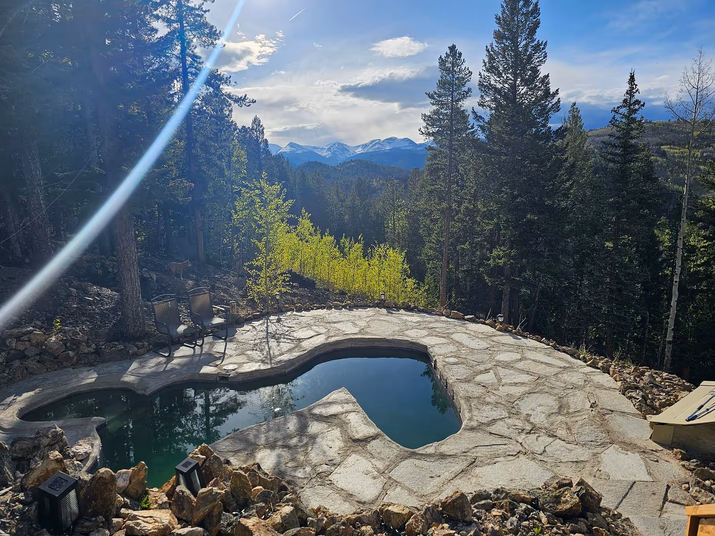Raspberry hot springs pool overlooking a mountain valley and forest
