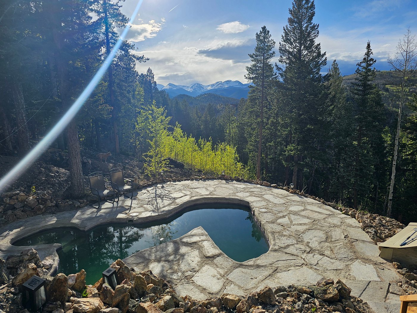 Raspberry hot springs pool overlooking a mountain valley and forest