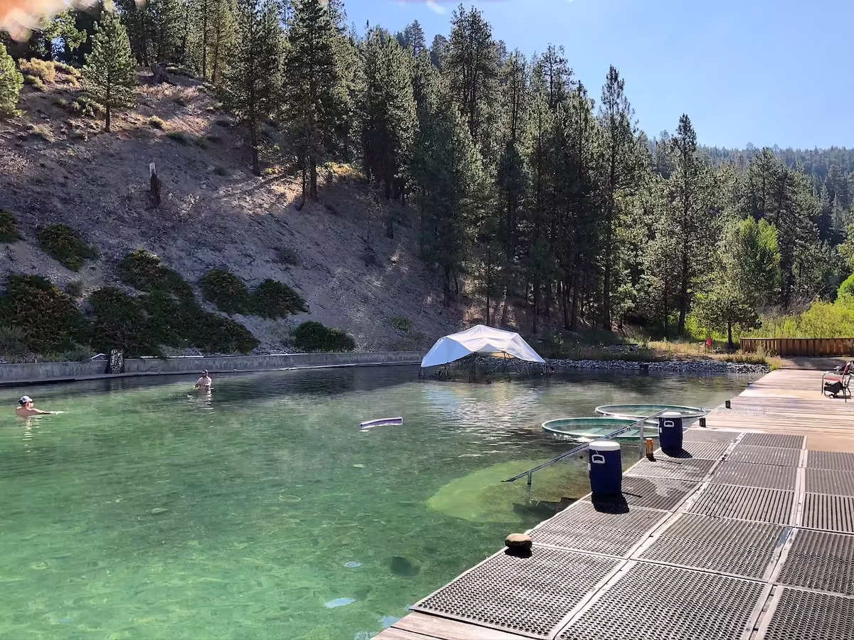 Trinity Hot Springs, Idaho - large outdoor geothermal pool with forested hills and resort