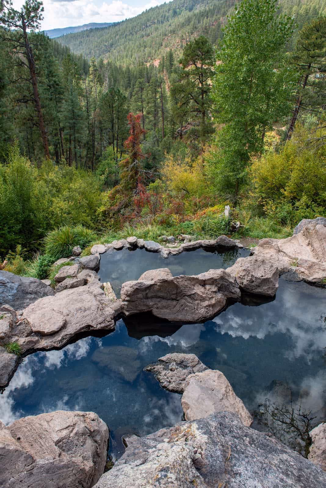 Spence Hot Spring New Mexico - tiered rock pools on a hillside above the Jemez River with cave pool