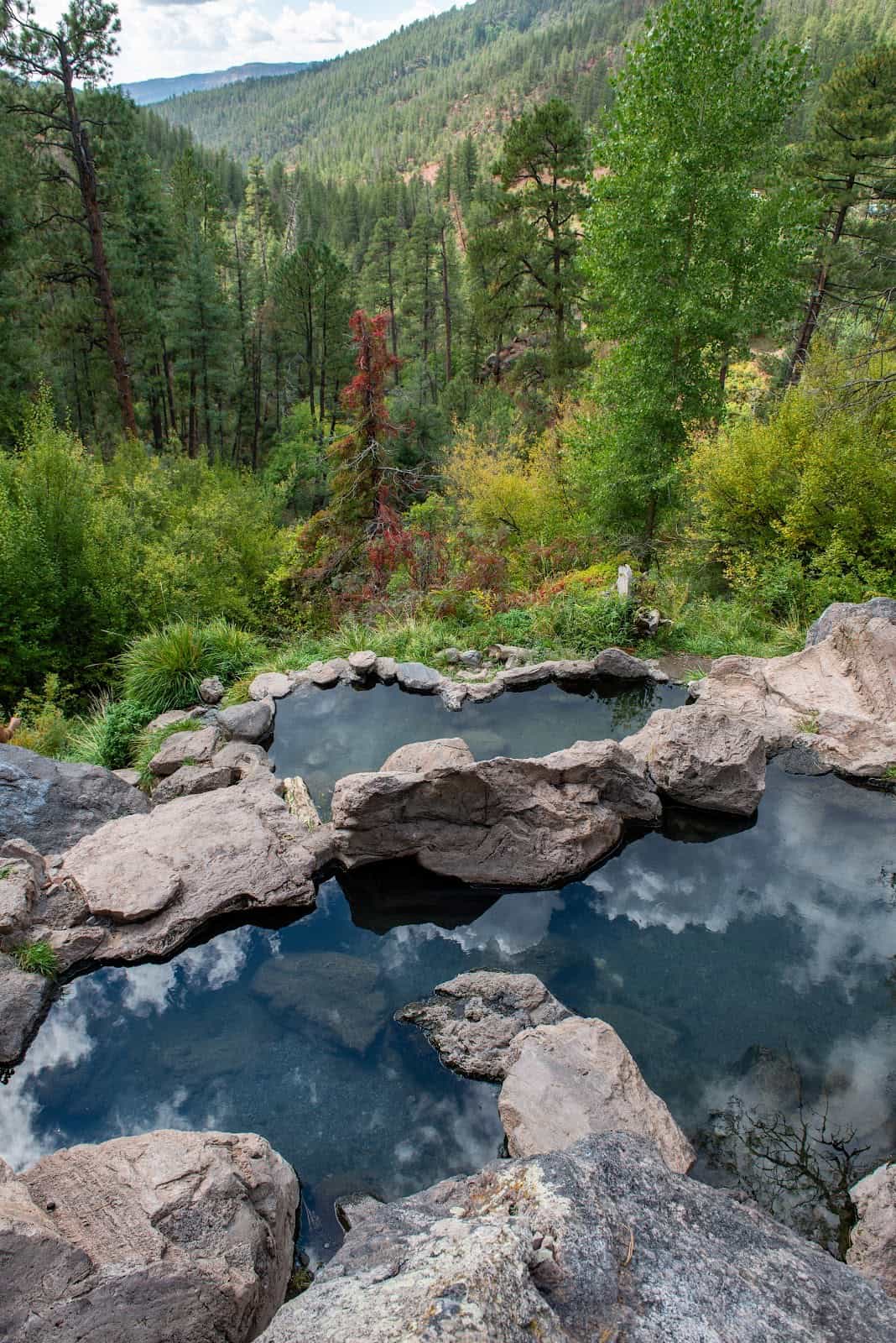 Spence Hot Spring New Mexico - tiered rock pools on a hillside above the Jemez River with cave pool