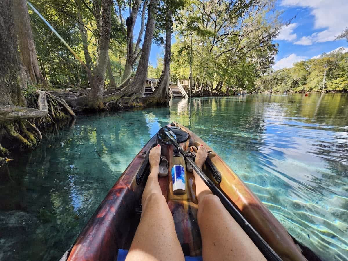 Ginnie Springs, Florida - crystal-clear spring pool surrounded by cypress and hardwood trees with diving platforms at the edge of the Santa Fe River