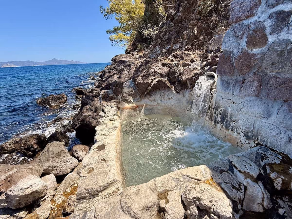 Pausanias Baths, Greece - small rock pool beside the sea on the volcanic Methana peninsula coast