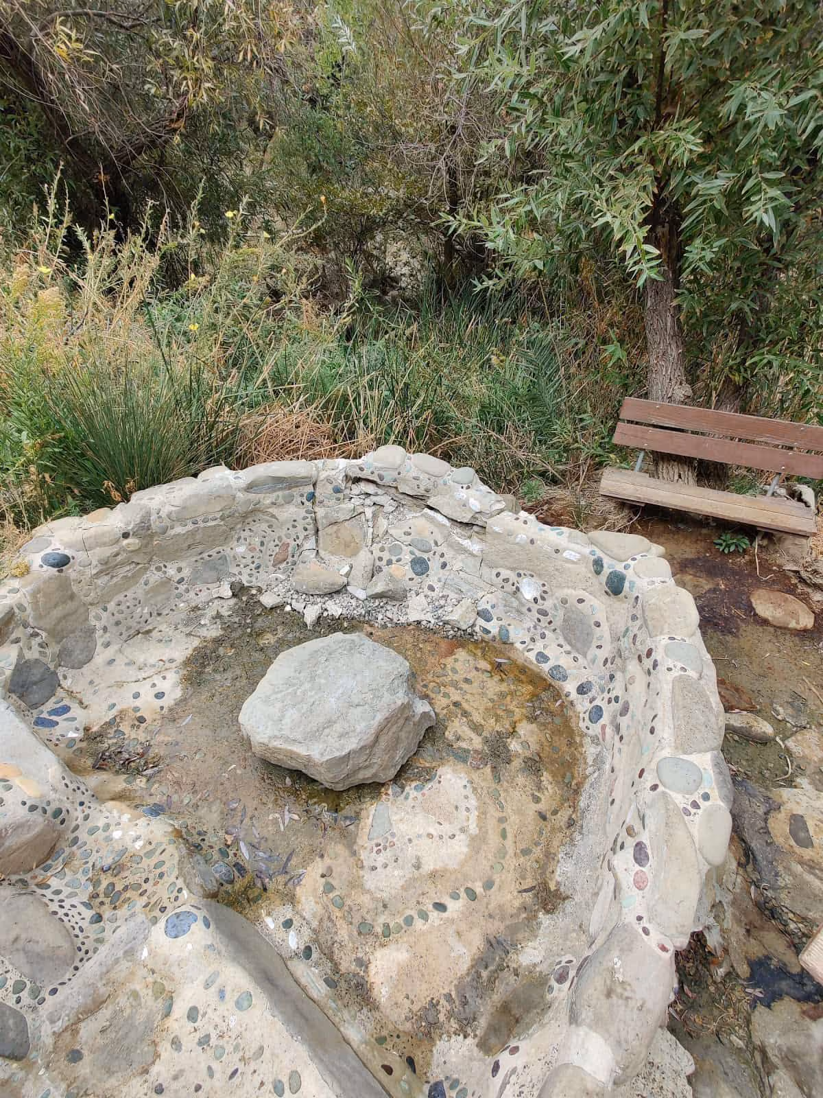 Big Caliente Hot Springs, California - concrete soaking pool adjacent to parking area in forested canyon in Los Padres National Forest
