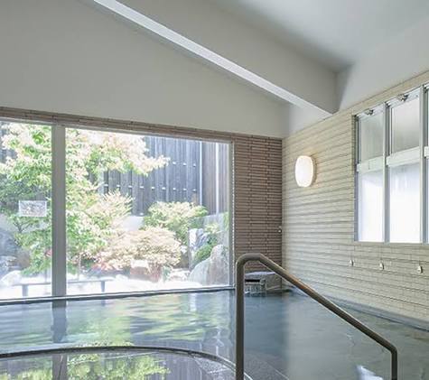 indoor hot spring pool with outdoor nature views in asama onsen 