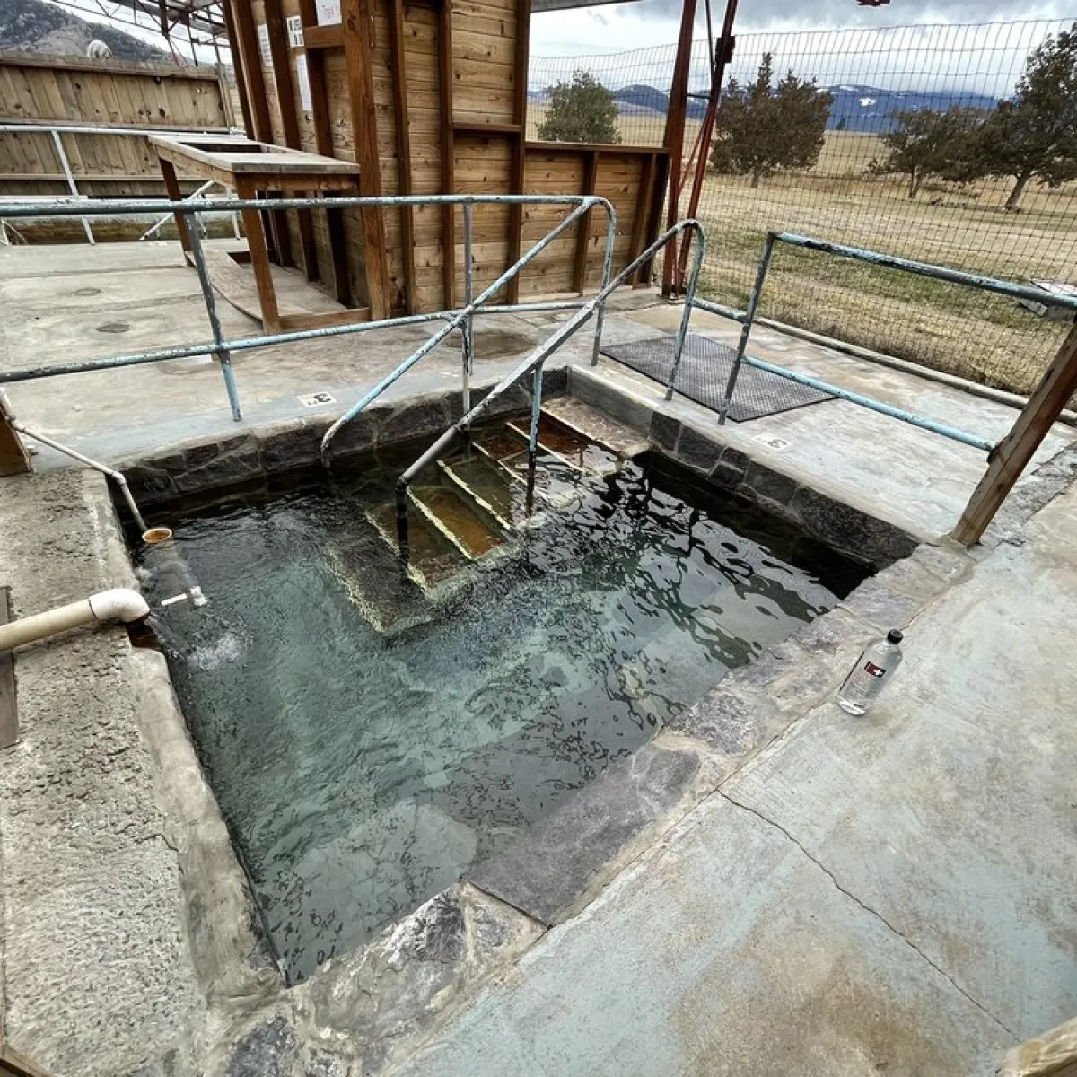 concrete hot spring tub with clear water at camp aqua hot springs