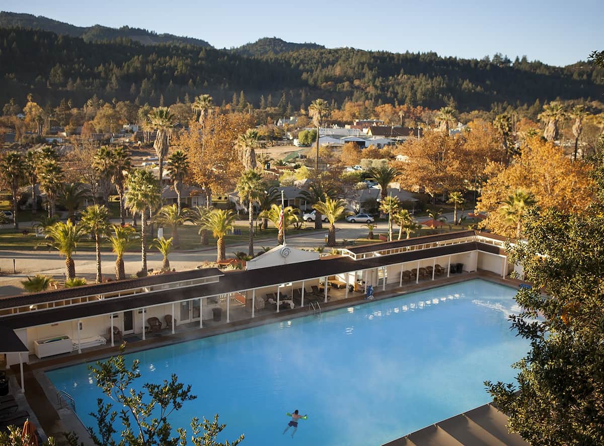 Outdoor hot spring pool with autumn foliage backdrop at indian springs calistoga california