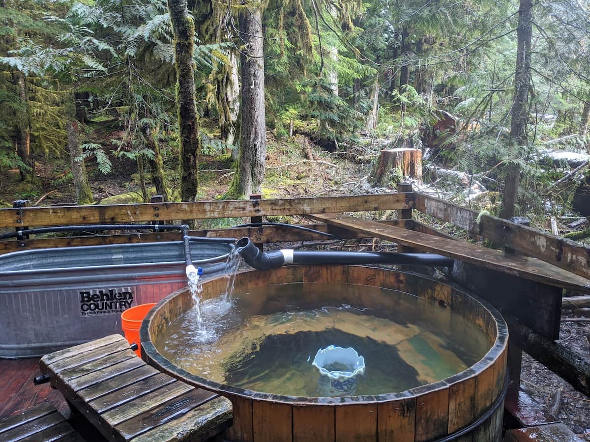Outdoor wooden hot tub with a forest backdrop at bagby hot springs oregon