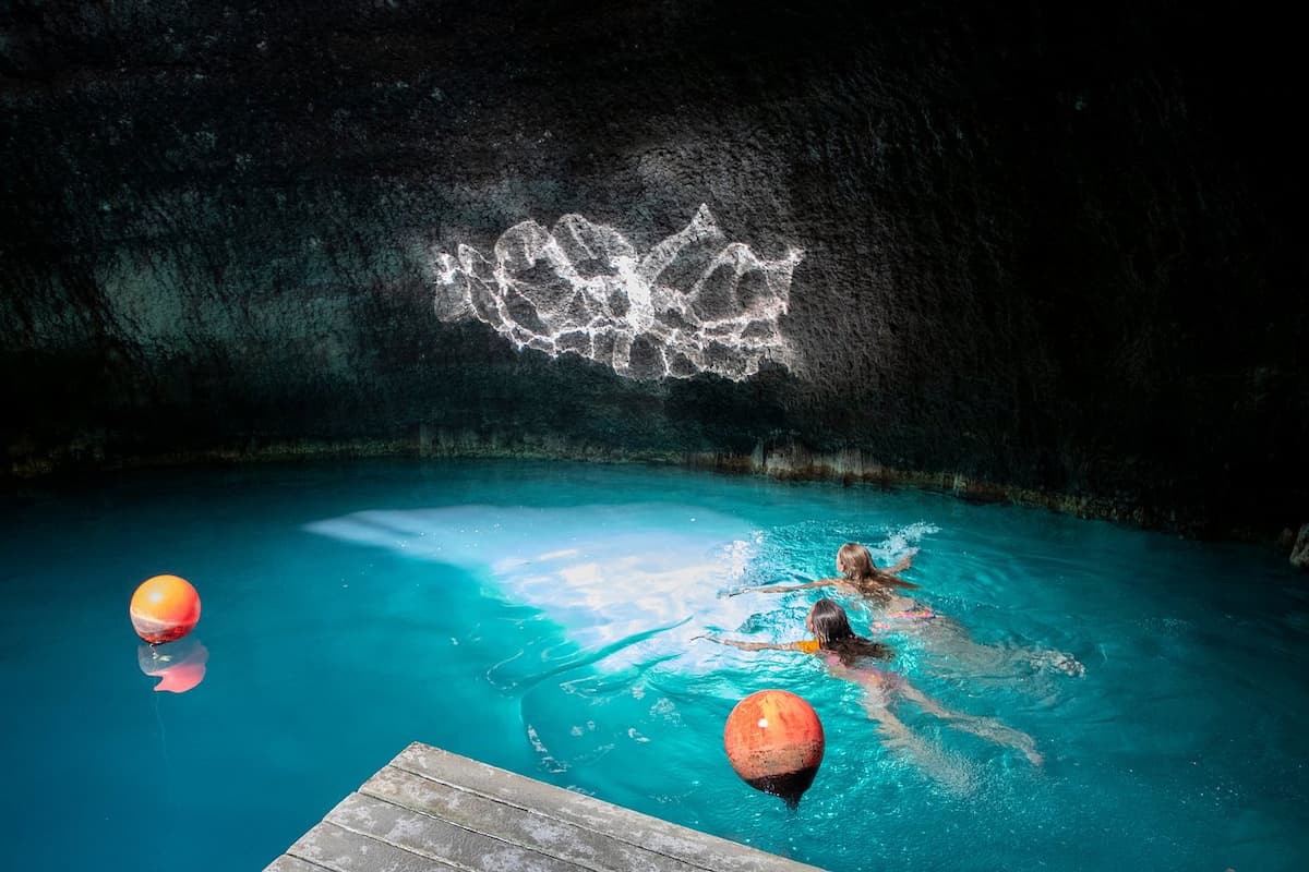 people swimming in hot spring creater at homestead crater utah