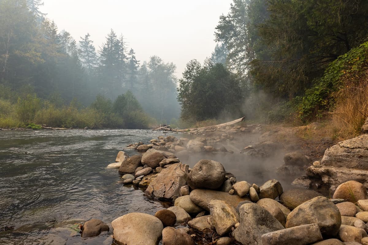 Riverside natural hot spring pool with steam coming out at mccreddie hot springs oregon