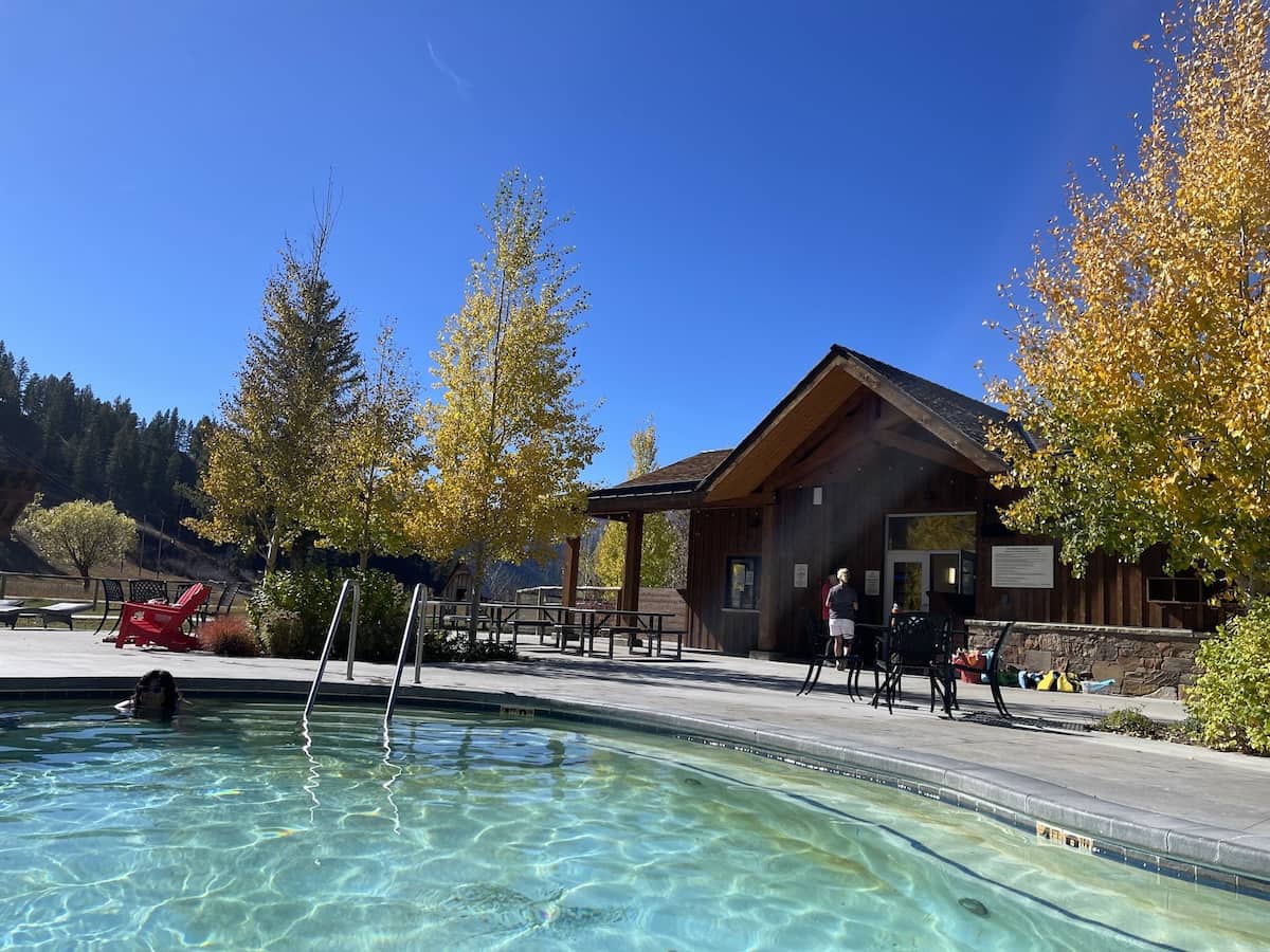 Outdoor turquoise water hot spring pool in autumn setting in astoria hot springs wyoming