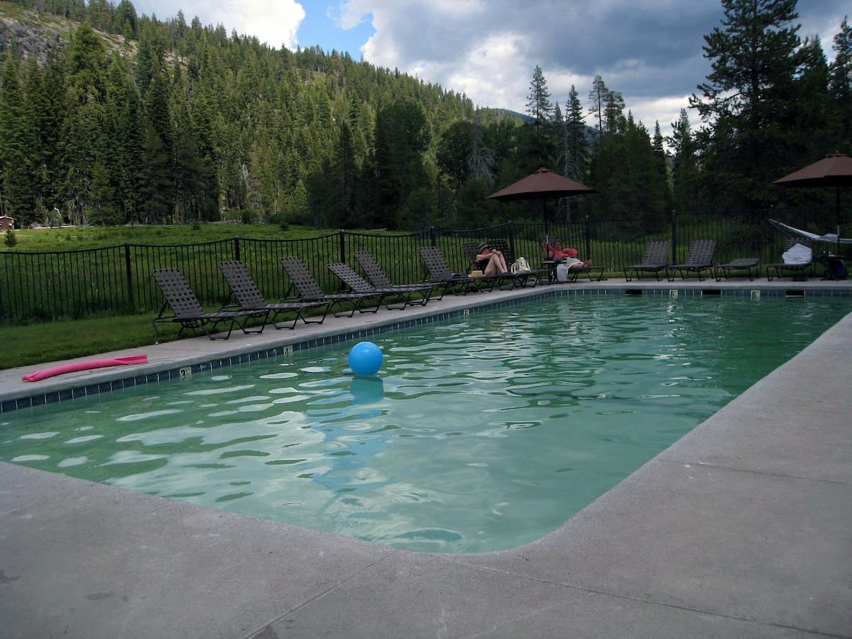 Outdoor hot spring pool with mountain backdrop at drakesbad guest ranch california