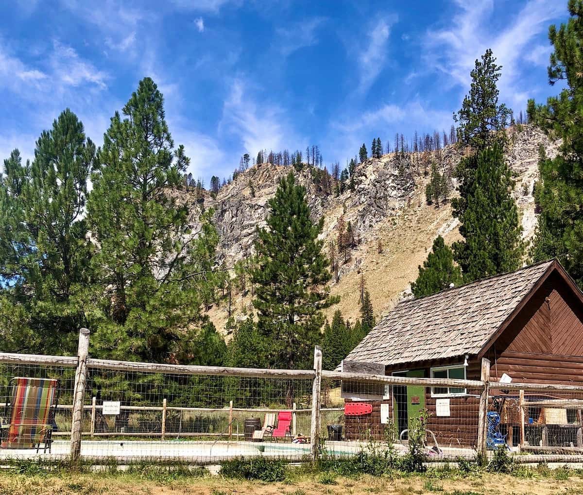 Outdoor hot spring pool and cabin with mountain views at sawtooth lodge hot springs idaho