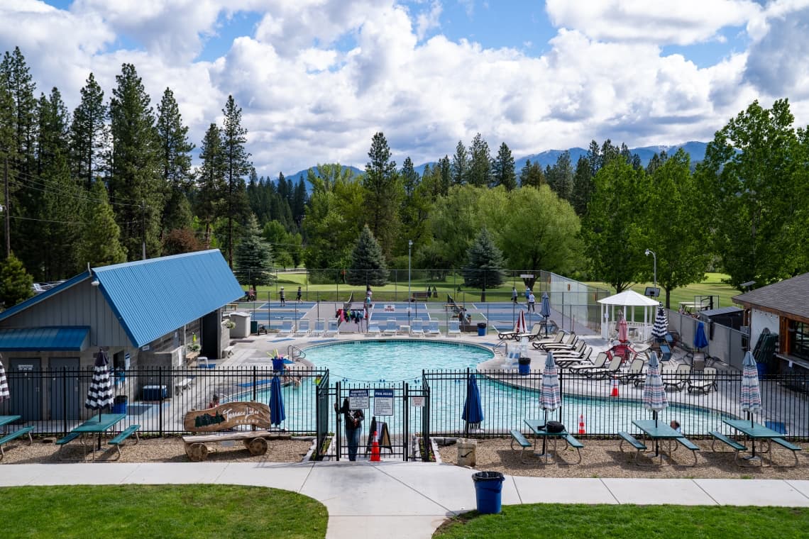 Outdoor hot spring pool and sports courts with forest valley views at terrace lakes hot springs idaho