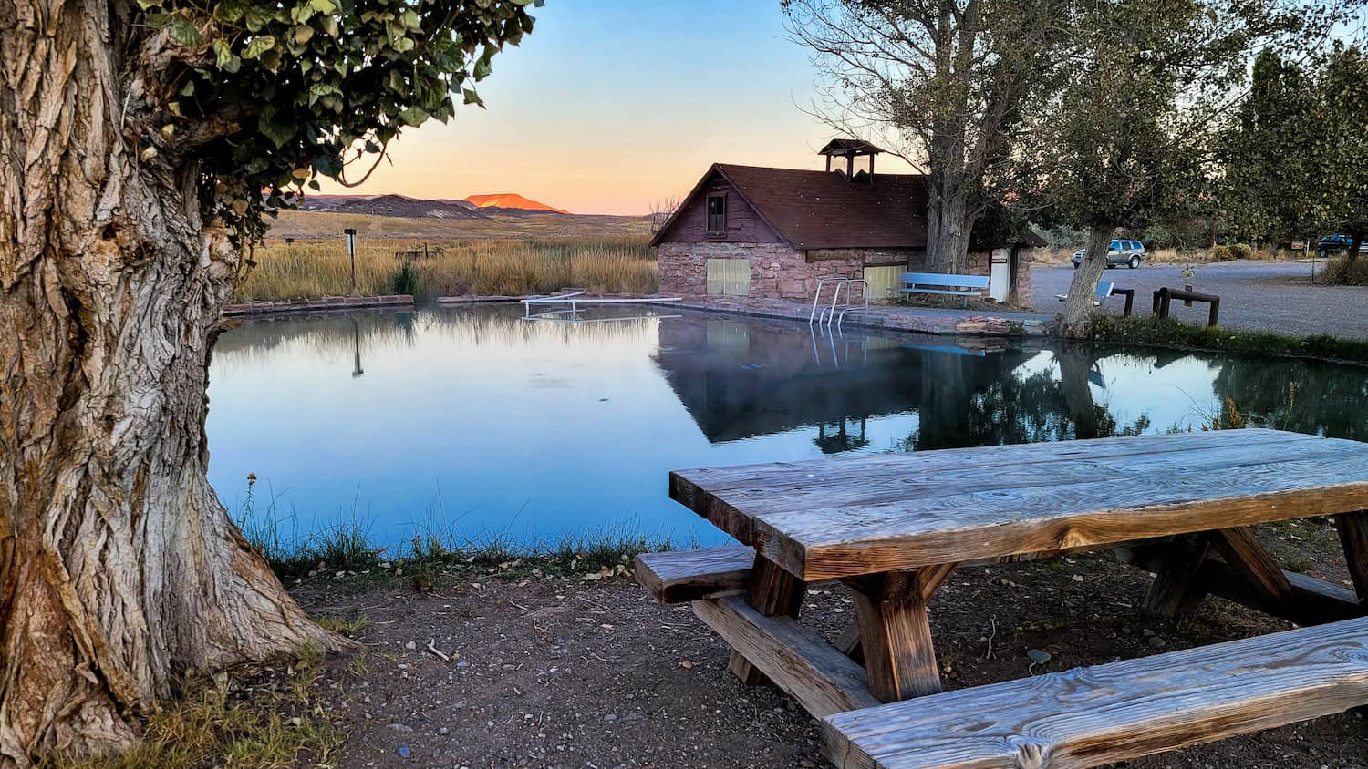 Outdoor Hot spring pool and picnic table with desert views in virgin valley hot springs nevada