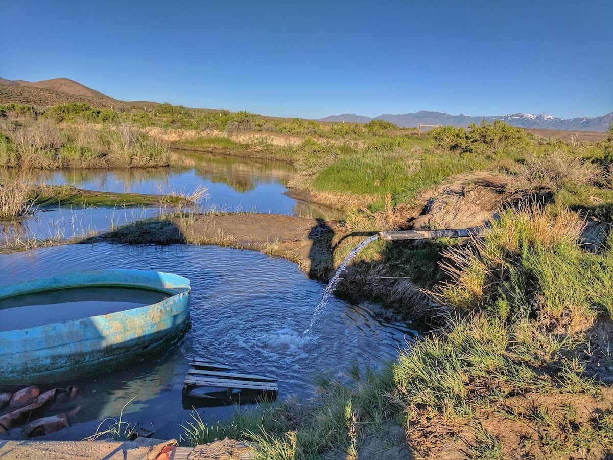 Hot spring bath tub and stream with desert views in paradise valley hot springs nevada